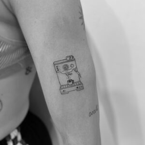 Mini tatuaje de cafetera en línea fina en brazo